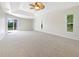 Large main bedroom with neutral carpet, ceiling fan, and outdoor access at 13210 Essman Ave, Port Charlotte, FL 33953