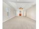 Spacious main bedroom featuring tray ceiling, ceiling fan, carpeted floor and neutral color palette at 13210 Essman Ave, Port Charlotte, FL 33953