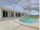 Screened in pool area with views of the natural surroundings at 13210 Essman Ave, Port Charlotte, FL 33953