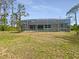 Backyard featuring an in-ground pool and screened-in lanai and grassy yard at 13210 Essman Ave, Port Charlotte, FL 33953