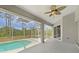 Screened-in lanai featuring an inground pool and an outdoor ceiling fan at 13210 Essman Ave, Port Charlotte, FL 33953
