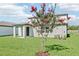 A spacious backyard features a lush lawn and a charming covered patio, perfect for outdoor relaxation and entertaining at 1740 Brekey Way, Zephyrhills, FL 33541