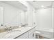 Modern bathroom featuring double sinks with granite countertops and a tub-shower combo at 1740 Brekey Way, Zephyrhills, FL 33541