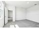 Bright bedroom featuring neutral carpeting and a view into an adjacent room at 1740 Brekey Way, Zephyrhills, FL 33541