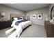 Serene bedroom with a tufted headboard, soft lighting, neutral tones, and contemporary decor at 1740 Brekey Way, Zephyrhills, FL 33541