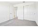 Carpeted bedroom with a closet and doorway to another room at 1740 Brekey Way, Zephyrhills, FL 33541