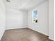 Bright bedroom featuring a window view and wood-look tile flooring at 1740 Brekey Way, Zephyrhills, FL 33541