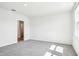 Cozy bedroom with neutral carpet, ample light, and doorway to adjacent room at 1740 Brekey Way, Zephyrhills, FL 33541