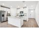 Open kitchen featuring white cabinets, granite counters, stainless steel appliances, and island at 1740 Brekey Way, Zephyrhills, FL 33541