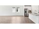 Bright and airy living room flows into a kitchen featuring stainless steel appliances and granite countertops at 1740 Brekey Way, Zephyrhills, FL 33541