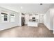 This bright, open-concept living space features tile floors and a seamless flow to the modern kitchen at 1740 Brekey Way, Zephyrhills, FL 33541
