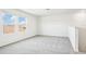 Well-lit loft space with neutral carpeting, offering flexibility for various uses at 1740 Brekey Way, Zephyrhills, FL 33541