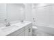 Modern bathroom featuring a dual-sink vanity with quartz countertop and tiled tub at 1799 Draughton Dr, Zephyrhills, FL 33541