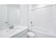 Modern bathroom features tiled shower and tub, white quartz vanity, and fixtures at 1799 Draughton Dr, Zephyrhills, FL 33541
