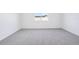 Bright, carpeted bedroom with neutral walls and a large window letting in natural light at 1799 Draughton Dr, Zephyrhills, FL 33541