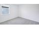 Bedroom featuring neutral carpet, window with blinds and bright white walls at 1799 Draughton Dr, Zephyrhills, FL 33541