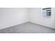 Cozy bedroom with wall-to-wall carpeting and a window providing natural light at 1799 Draughton Dr, Zephyrhills, FL 33541