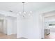 Open floor plan with a modern chandelier above the dining space near the kitchen at 1799 Draughton Dr, Zephyrhills, FL 33541