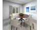 Bright dining room with a round table, comfortable seating, and stylish décor at 1799 Draughton Dr, Zephyrhills, FL 33541