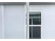 A close up of the backyard exterior, showing the sliding glass doors and lawn at 1799 Draughton Dr, Zephyrhills, FL 33541