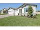 Manicured front yard with a view of the home's exterior at 1799 Draughton Dr, Zephyrhills, FL 33541