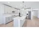 Bright, modern kitchen with white cabinets, stainless steel appliances, a central island, and light wood flooring at 1799 Draughton Dr, Zephyrhills, FL 33541