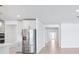 Stylish kitchen with stainless steel appliances and a view into the hallway at 1799 Draughton Dr, Zephyrhills, FL 33541