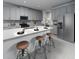 Contemporary kitchen featuring sleek gray cabinets, stainless steel appliances, and a spacious breakfast bar at 1799 Draughton Dr, Zephyrhills, FL 33541