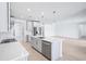 Modern kitchen with a center island, stainless steel appliances, and an open concept layout to the living room at 1799 Draughton Dr, Zephyrhills, FL 33541