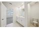 Bathroom featuring double sink vanity, tile flooring, and views into bedroom at 1859 Draughton Dr, Zephyrhills, FL 33541