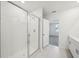 Bright bathroom featuring a glass-enclosed shower and a modern vanity with tiled floors at 1859 Draughton Dr, Zephyrhills, FL 33541