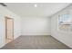 Bright bedroom with neutral carpet, white walls, and a large window for ample natural light at 1859 Draughton Dr, Zephyrhills, FL 33541