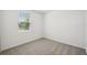Cozy bedroom with a window and plush carpet flooring at 1859 Draughton Dr, Zephyrhills, FL 33541