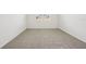 Neutral bedroom with plush carpeting, a large window, and ample space for furnishings at 1859 Draughton Dr, Zephyrhills, FL 33541