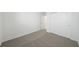 A clean and spacious bedroom with plush carpeting and a closet perfect for storage at 1859 Draughton Dr, Zephyrhills, FL 33541