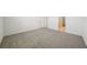 Spacious bedroom featuring plush carpeting and ample natural light from an open doorway at 1859 Draughton Dr, Zephyrhills, FL 33541