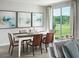 Sunlit dining area with modern art, a decorative table setting, and sliding glass doors to the backyard at 1859 Draughton Dr, Zephyrhills, FL 33541