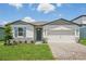 Charming single-story home with stone accents, a two-car garage, and a manicured lawn at 1859 Draughton Dr, Zephyrhills, FL 33541