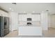 Modern open kitchen with stainless steel appliances, white cabinets, and a large center island at 1859 Draughton Dr, Zephyrhills, FL 33541
