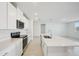 Modern kitchen featuring stainless steel appliances, a center island with a sink and bright lighting at 1859 Draughton Dr, Zephyrhills, FL 33541