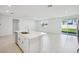 Open-concept kitchen featuring a large island with sink and bar seating, sliding glass doors to patio at 1859 Draughton Dr, Zephyrhills, FL 33541