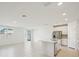 A bright living room featuring tile floors, recessed lights, and an open floor plan at 1859 Draughton Dr, Zephyrhills, FL 33541