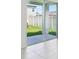 The sliding glass doors open to a backyard with green grass and a privacy fence at 1859 Draughton Dr, Zephyrhills, FL 33541