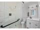 Modern bathroom featuring a glass-enclosed shower, sleek vanity, and contemporary lighting at 2110 W Farwell Dr, Tampa, FL 33603