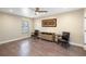 Spacious room with hardwood flooring, fan, window, and neutral tones at 2110 W Farwell Dr, Tampa, FL 33603