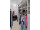 Organized walk-in closet with custom shelving, hanging rods, and elegant lighting at 2110 W Farwell Dr, Tampa, FL 33603