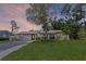 Charming single-story home featuring a spacious front yard, landscaped lawn, and a quaint covered entryway at 2110 W Farwell Dr, Tampa, FL 33603