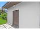 Exterior shot of a garage with a corrugated door, and a manicured lawn area at 2110 W Farwell Dr, Tampa, FL 33603