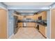 Spacious kitchen features stainless steel appliances, wood cabinets, and tile floors at 2110 W Farwell Dr, Tampa, FL 33603