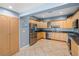 Open kitchen featuring stainless steel appliances, light wood cabinets, and tile flooring at 2110 W Farwell Dr, Tampa, FL 33603